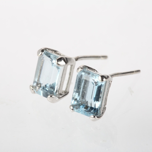 1181 - A pair of aquamarine earrings, each claw set with 1ct octagonal step-cut aquamarine, unmarked white ... 