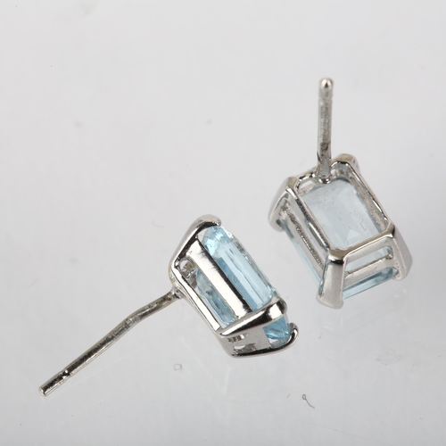 1181 - A pair of aquamarine earrings, each claw set with 1ct octagonal step-cut aquamarine, unmarked white ... 