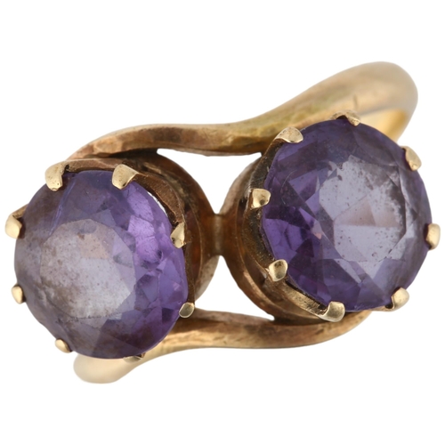 1190 - A late 20th century two stone synthetic sapphire crossover ring, claw set with 8.5mm sapphires, appa... 