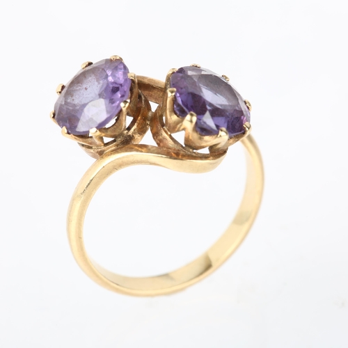 1190 - A late 20th century two stone synthetic sapphire crossover ring, claw set with 8.5mm sapphires, appa... 