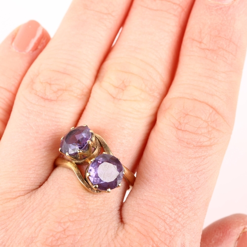 1190 - A late 20th century two stone synthetic sapphire crossover ring, claw set with 8.5mm sapphires, appa... 