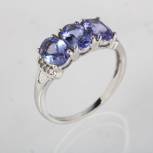 1198 - A modern 9ct white gold tanzanite and diamond dress ring, claw set with oval mixed-cut tanzanites an... 