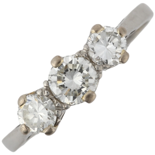 1201 - A platinum three stone diamond ring, 20th century, claw set with modern round brilliant-cut diamonds... 