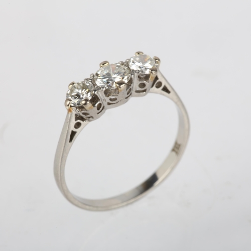 1201 - A platinum three stone diamond ring, 20th century, claw set with modern round brilliant-cut diamonds... 