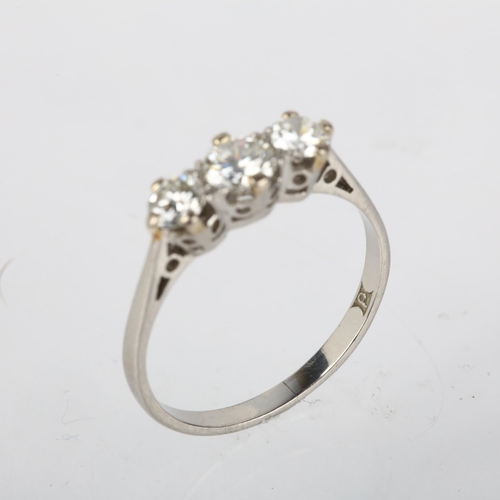 1201 - A platinum three stone diamond ring, 20th century, claw set with modern round brilliant-cut diamonds... 