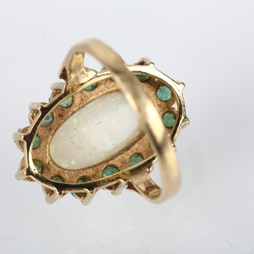 1202 - A late 20th century 9ct gold opal and emerald oval cluster ring, maker RJ, London 1976, claw set wit... 