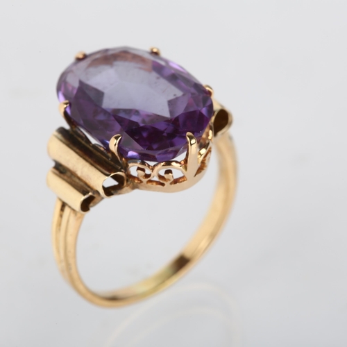 1208 - A late 20th century synthetic sapphire dress ring, unmarked gold set with oval mixed-cut synthetic s... 