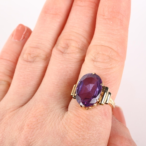 1208 - A late 20th century synthetic sapphire dress ring, unmarked gold set with oval mixed-cut synthetic s... 