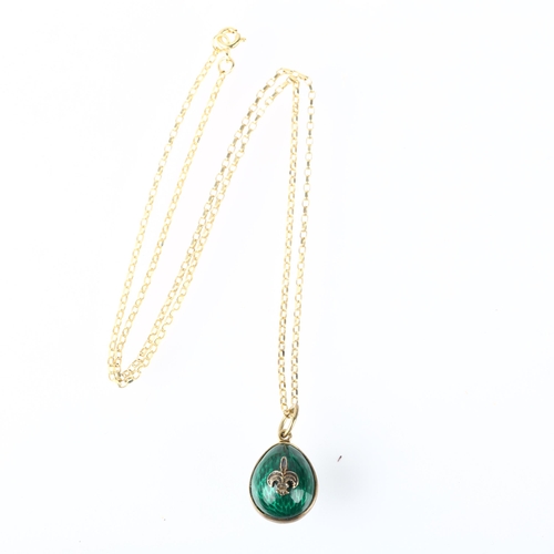 1215 - A late 20th century green enamel egg pendant necklace, on 9ct fine cable link chain, with fleur-de-l... 