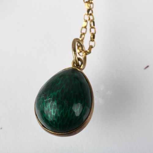 1215 - A late 20th century green enamel egg pendant necklace, on 9ct fine cable link chain, with fleur-de-l... 