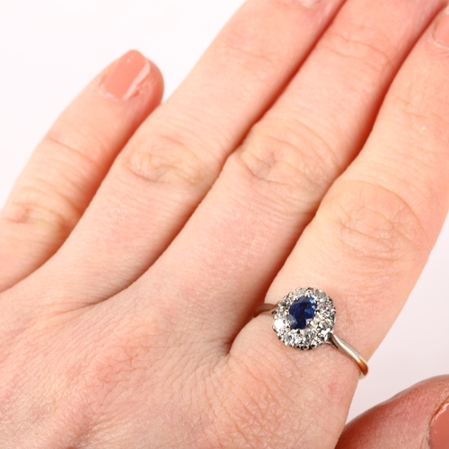 1232 - An 18ct gold sapphire and diamond oval cluster ring, claw set with oval mixed-cut sapphire and singl... 