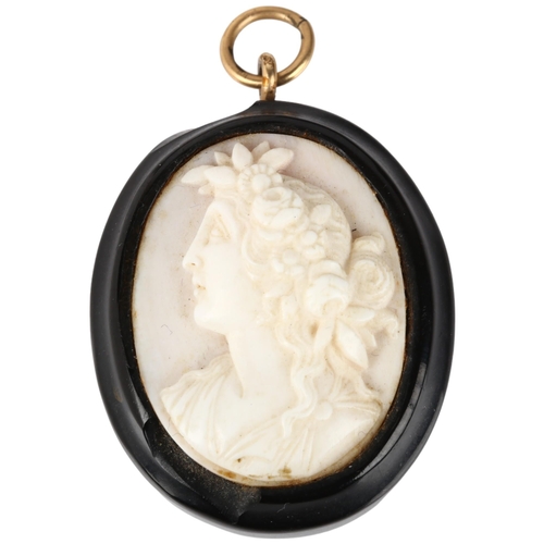 1237 - A 19th century coral cameo pendant, relief carved depicting Classical female profile, 40.4mm, 10.6g