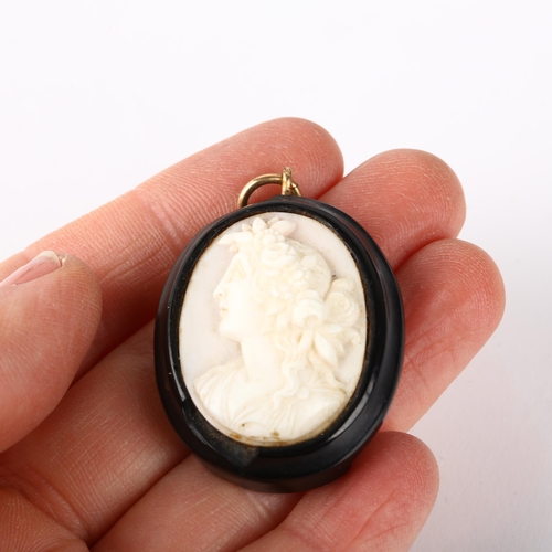 1237 - A 19th century coral cameo pendant, relief carved depicting Classical female profile, 40.4mm, 10.6g