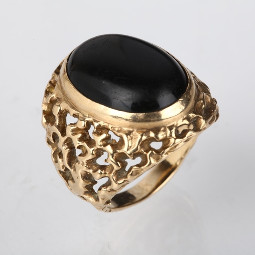 1238 - A large 9ct gold onyx signet ring, circa 1970s, setting height 25.1mm, size approx P, 10.6g