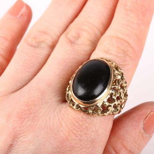 1238 - A large 9ct gold onyx signet ring, circa 1970s, setting height 25.1mm, size approx P, 10.6g