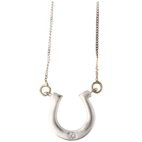 1250 - A modern 9ct white gold diamond horse shoe pendant necklace, set with 0.025ct modern round brilliant... 