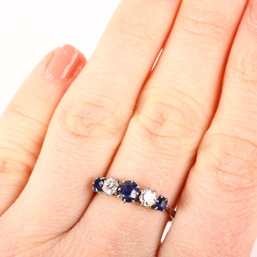 1253 - An 18ct gold graduated five stone sapphire and diamond ring, claw set with oval mixed-cut sapphires ... 