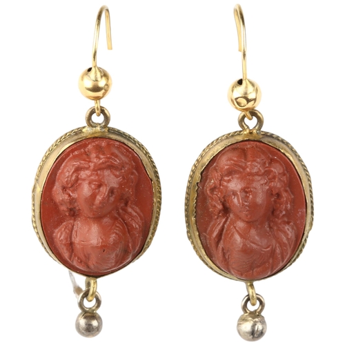 1264 - A pair of Victorian Revival composition cameo earrings, circa 1940s, brass rope twist frames with re... 