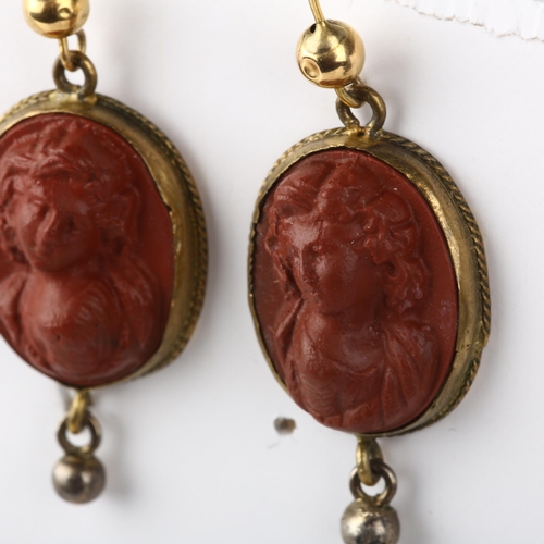 1264 - A pair of Victorian Revival composition cameo earrings, circa 1940s, brass rope twist frames with re... 