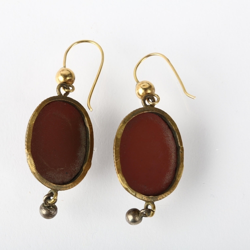 1264 - A pair of Victorian Revival composition cameo earrings, circa 1940s, brass rope twist frames with re... 