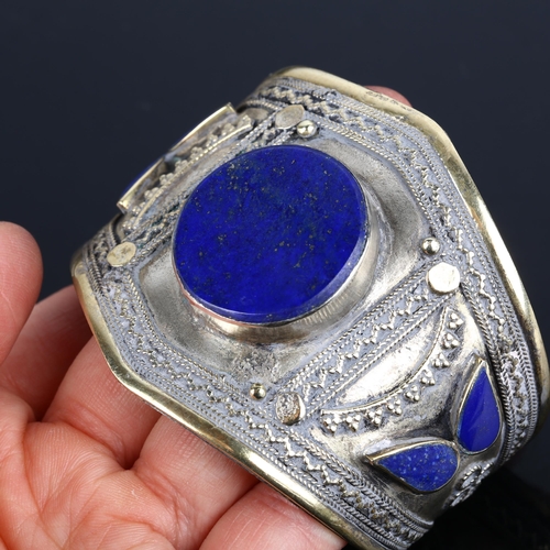 1363 - An Afghan Ethnic lapis lazuli cuff bangle, apparently unmarked, setting height 56.2mm, internal circ... 