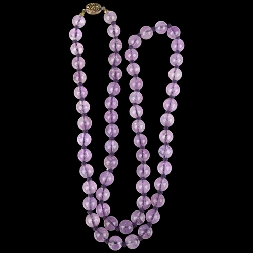 1365 - A Chinese amethyst bead necklace, each 10mm bead individually knotted, with silver-gilt filigree cla... 