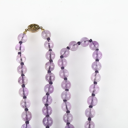 1365 - A Chinese amethyst bead necklace, each 10mm bead individually knotted, with silver-gilt filigree cla... 