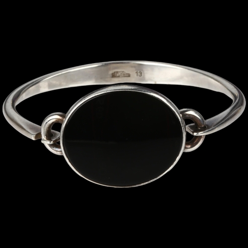 1374 - NIELS ERIK FROM - a Danish modernist sterling silver and onyx torque bangle, model no. 13, setting h... 