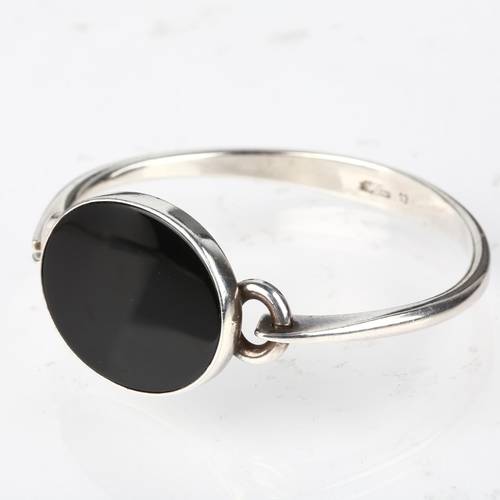 1374 - NIELS ERIK FROM - a Danish modernist sterling silver and onyx torque bangle, model no. 13, setting h... 