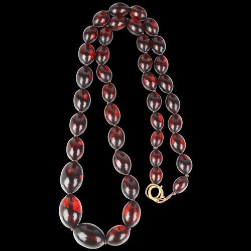 1419 - A graduated single-strand Cherry Bakelite bead necklace, beads measure 27.0 - 15.7mm, necklace 80cm,... 