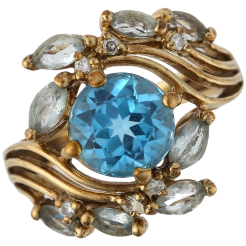 1274 - A modern 9ct gold blue topaz and diamond floral crossover ring, setting height 16.7mm, size K, 4g