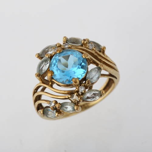 1274 - A modern 9ct gold blue topaz and diamond floral crossover ring, setting height 16.7mm, size K, 4g