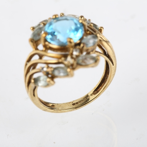 1274 - A modern 9ct gold blue topaz and diamond floral crossover ring, setting height 16.7mm, size K, 4g