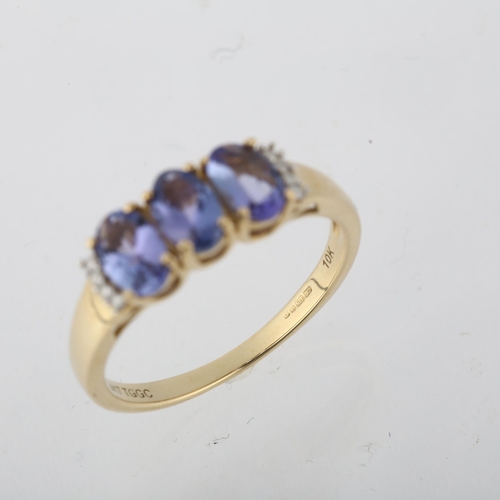 1280 - A modern 9ct gold tanzanite and diamond half hoop ring, setting height 6mm, size N, 2.1g