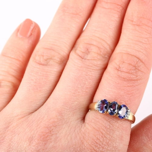 1280 - A modern 9ct gold tanzanite and diamond half hoop ring, setting height 6mm, size N, 2.1g