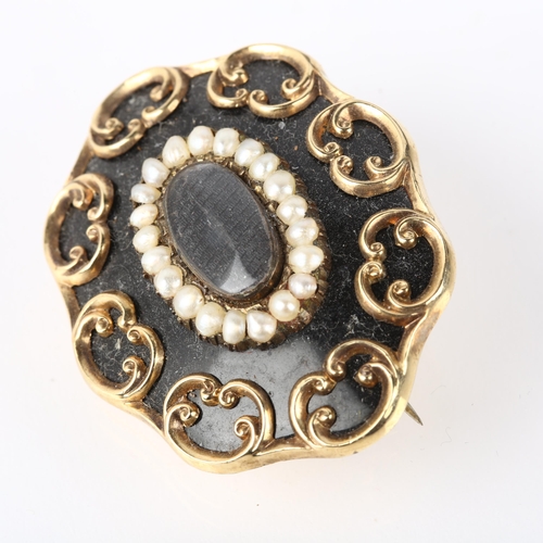 1282 - A Victorian black enamel and split pearl mourning brooch, central moire silk panel beneath convex gl... 