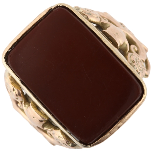 1292 - A large early 20th century 9ct gold carnelian signet ring, converted from a fob, with applied and pi... 