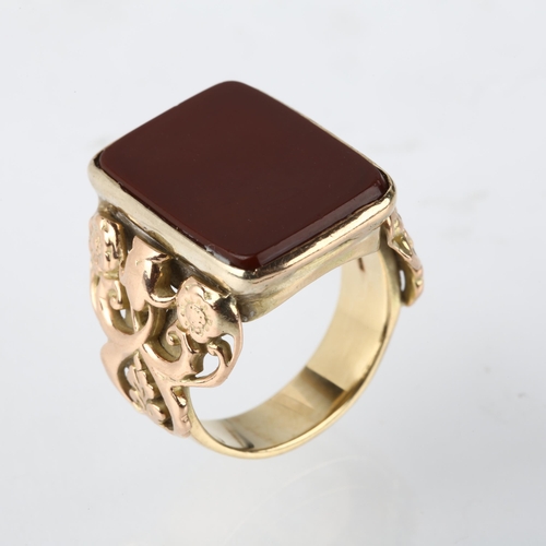 1292 - A large early 20th century 9ct gold carnelian signet ring, converted from a fob, with applied and pi... 