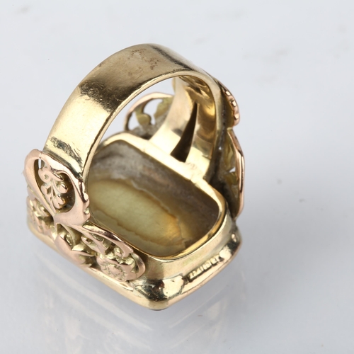 1292 - A large early 20th century 9ct gold carnelian signet ring, converted from a fob, with applied and pi... 