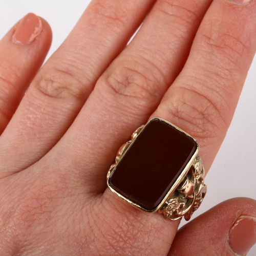 1292 - A large early 20th century 9ct gold carnelian signet ring, converted from a fob, with applied and pi... 