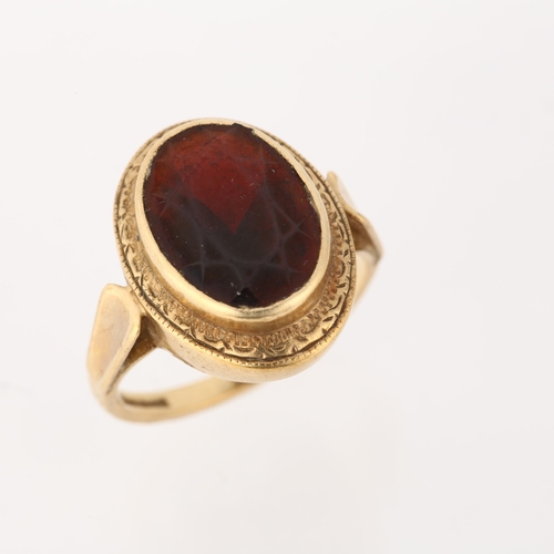 1294 - A 9ct gold garnet dress ring, rub-over set with oval mixed-cut garnet, setting height 18.2mm, size N... 