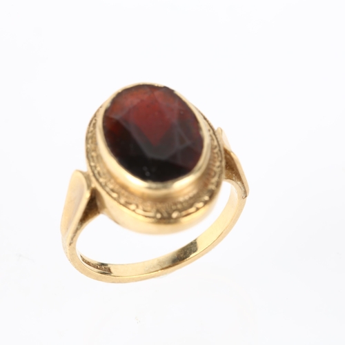 1294 - A 9ct gold garnet dress ring, rub-over set with oval mixed-cut garnet, setting height 18.2mm, size N... 