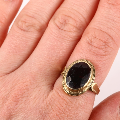 1294 - A 9ct gold garnet dress ring, rub-over set with oval mixed-cut garnet, setting height 18.2mm, size N... 