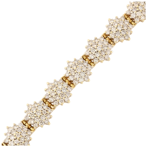 1298 - An 18ct gold diamond snowflake cluster line bracelet, maker LA, import Sheffield 1998, claw set with... 