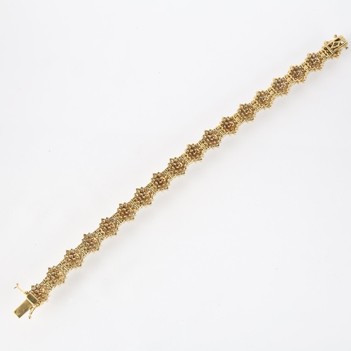 1298 - An 18ct gold diamond snowflake cluster line bracelet, maker LA, import Sheffield 1998, claw set with... 