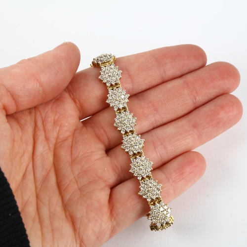 1298 - An 18ct gold diamond snowflake cluster line bracelet, maker LA, import Sheffield 1998, claw set with... 