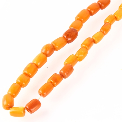 1303 - A single-strand butterscotch amber barrel bead necklace, beads measure 11.1 - 14.8mm, 56cm, 32.7g