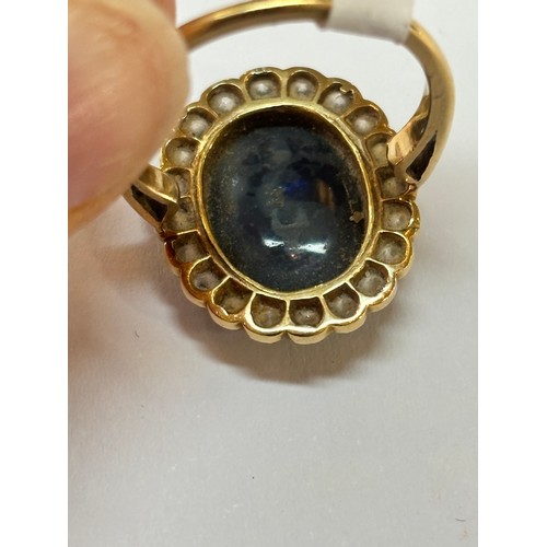 1130 - A black opal and diamond oval cluster ring, mid-20th century, rub-over set with 2.5ct oval cabochon ... 