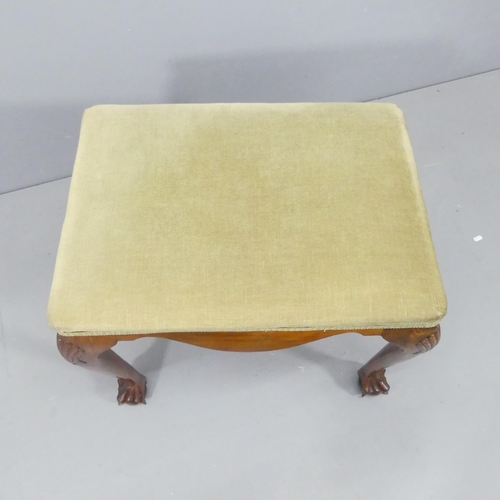 2124 - A continental walnut and upholstered footstool, with appllied carved decoration and raised on cabrio... 