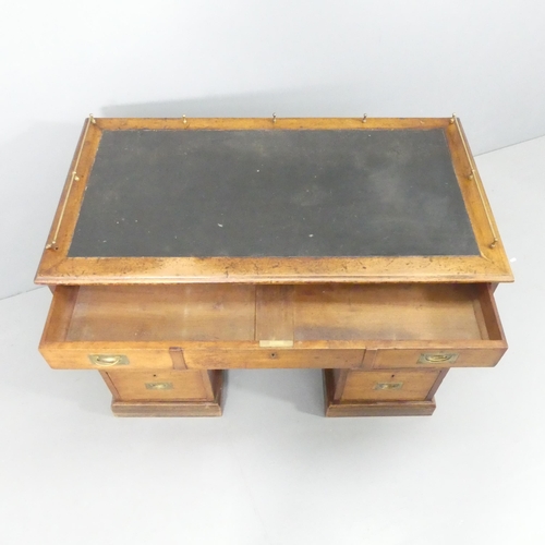 2137 - An antique mahogany campaign style twin pedestal writing desk, with seven drawers and brass handles.